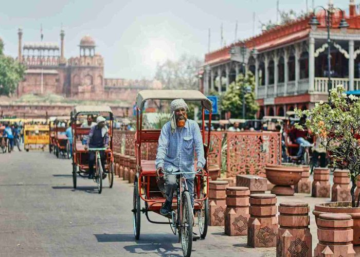 Tricycle Rickshaws Riding on a Street near Chandni Chowk Market, Dehli, India_11zon